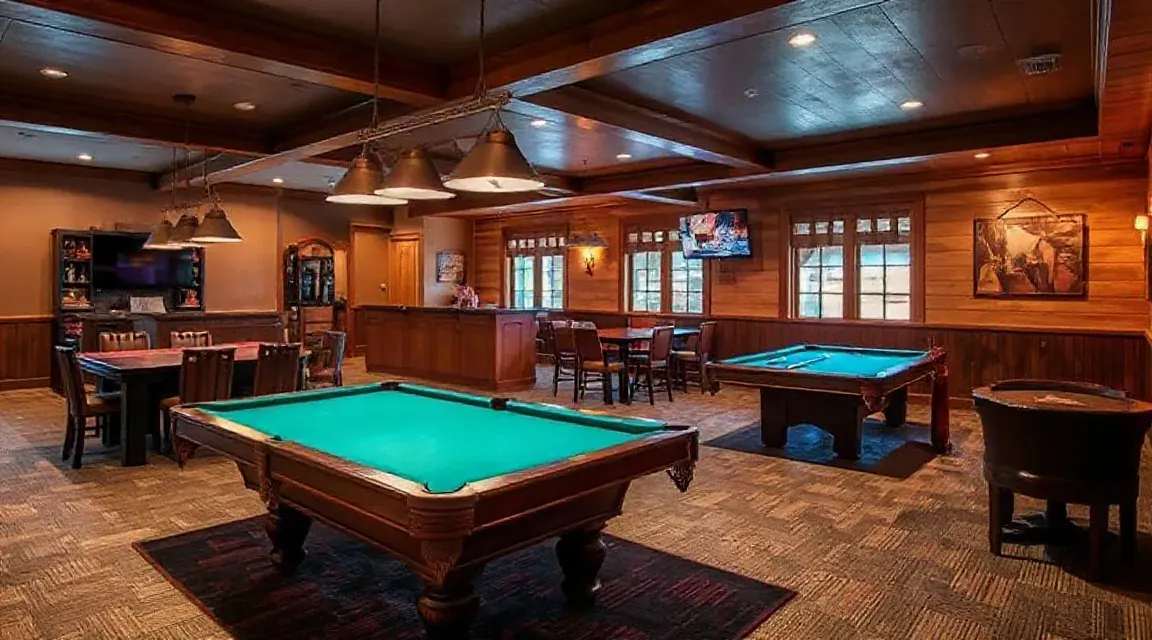 Games room with two pool tables, bar stools and a timber ceiling
